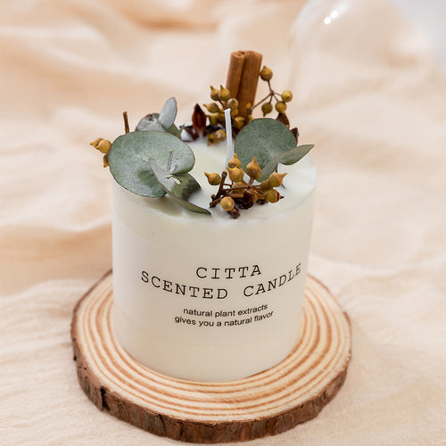 Hand poured botanical soy pillar candle with dried flowers set in the wax